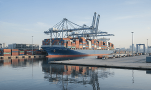 Cargo ship transporting vehicles at port